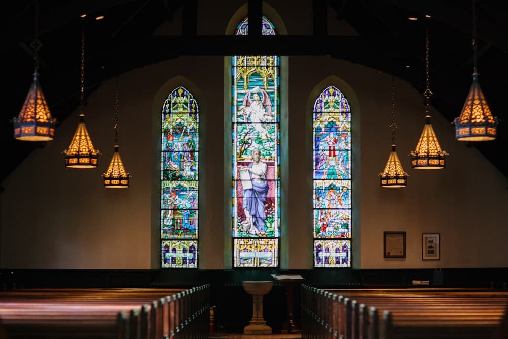 Church interior with stained glass windows and warm light